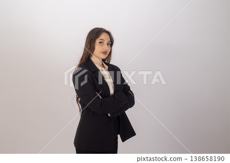 Businesswoman in suit posing with arms crossed Businesswoman in suit posing with arms crossed 138658190