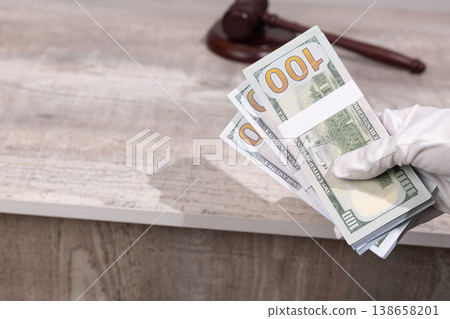 Wooden gavel with money and legal documents Wooden gavel with money and legal documents 138658201