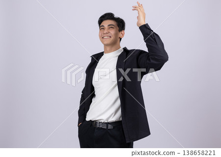 Young man gesturing with hand while looking at camera Young man gesturing with hand while looking at camera 138658221