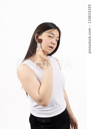 Pensive woman in white top posing with hand on her face Pensive woman in white top posing with hand on her face 138658385
