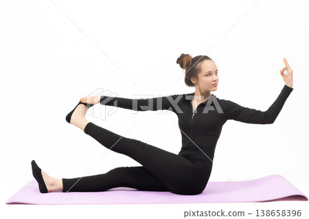 Flexible woman doing yoga stretching on mat Flexible woman doing yoga stretching on mat 138658396