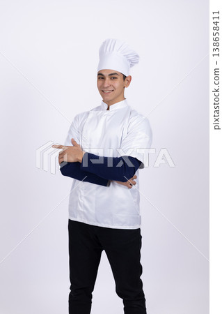 Professional chef in white uniform standing with crossed arms 138658411