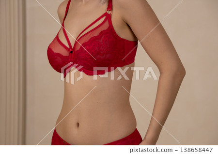 Close up of woman in red lace bra in studio Close up of woman in red lace bra in studio 138658447