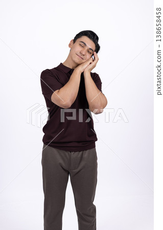 Man sleeping while standing with his hands on face Man sleeping while standing with his hands on face 138658458