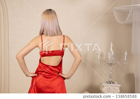 Back view of woman in red nightgown showing bare back Back view of woman in red nightgown showing bare back 138658588