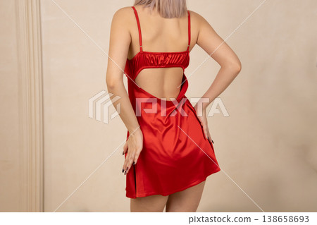 Back view of woman in red nightgown in studio Back view of woman in red nightgown in studio 138658693