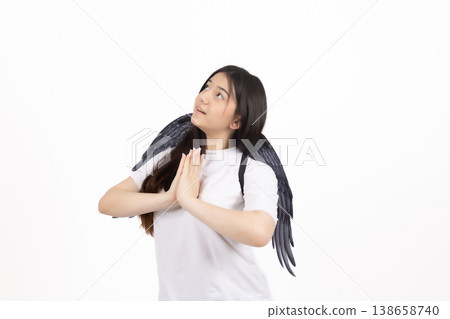 Woman praying with hands together and looking up in studio 138658740