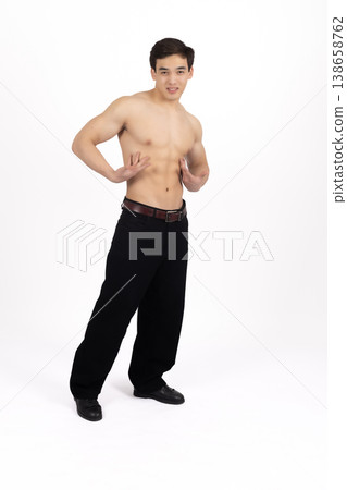 Fit man with bare chest posing sideways in studio Fit man with bare chest posing sideways in studio 138658762