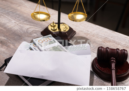 Justice scales with money and gavel in legal office Justice scales with money and gavel in legal office 138658767