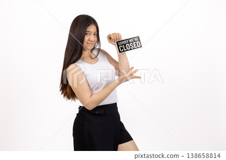 Woman in white shirt holding a small sign that says CLOSED Woman in white shirt holding a small sign that says CLOSED 138658814