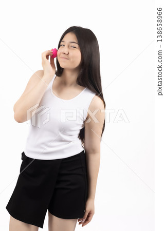 Woman talking on a smartphone and looking up in studio 138658966
