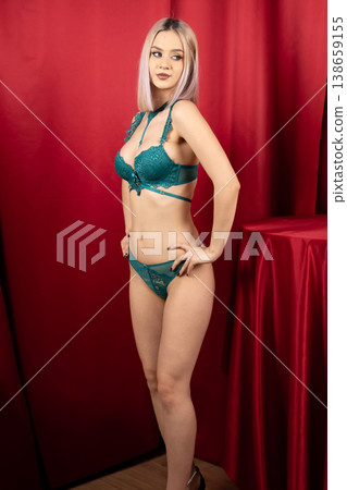 Full length of woman in green lingerie in studio Full length of woman in green lingerie in studio 138659155