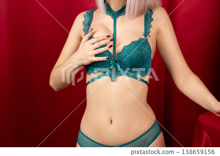 Beautiful woman in green lingerie looking at camera Beautiful woman in green lingerie looking at camera 138659156