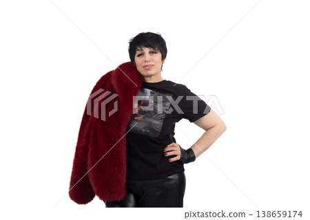 Beautiful woman in black outfit holding a burgundy fur coat Beautiful woman in black outfit holding a burgundy fur coat 138659174