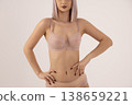 Beautiful woman in beige lingerie posing with hands on hips 138659221