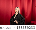 Stunning woman in black robe looking directly at camera 138659233