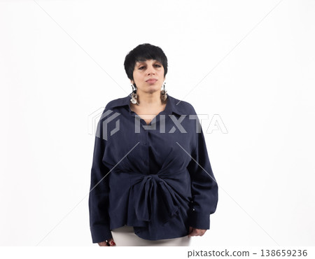 Portrait of a woman in a navy shirt looking at camera Portrait of a woman in a navy shirt looking at camera 138659236