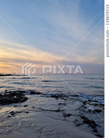 This is the Jeju beach where the sunset is setting. This is the Jeju beach where the sunset is setting. 138659314