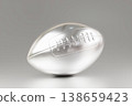 Metallic silver american football ball on clean grey background 138659423