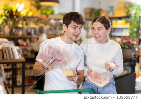 Couple choosing cheese and bacon at the supermarket Couple choosing cheese and bacon at the supermarket 138659777