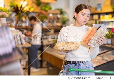 Young woman choosing pasta in grocery supermarket Young woman choosing pasta in grocery supermarket 138659801