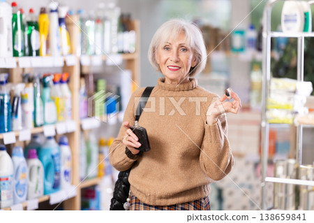 Elderly woman choosing perfume Elderly woman choosing perfume 138659841