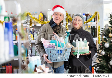 Couple man and woman choosing household chemicals in decorated store 138659871
