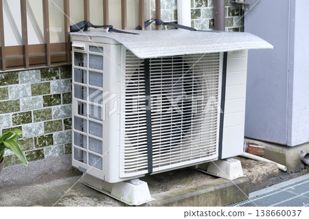 空調室外機，配有遮陽罩，用於阻擋強烈的陽光。 138660037