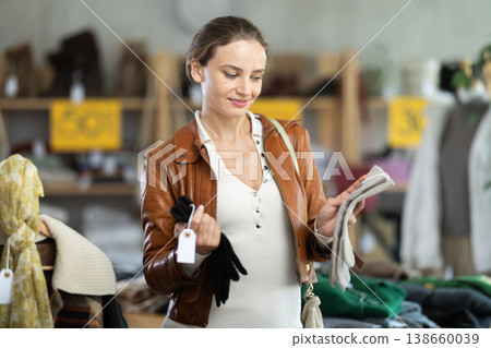 European woman customer examine and choose gloves in store 138660039