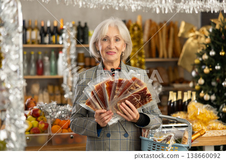 Elderly woman choosing jamon in grocery store Elderly woman choosing jamon in grocery store 138660092