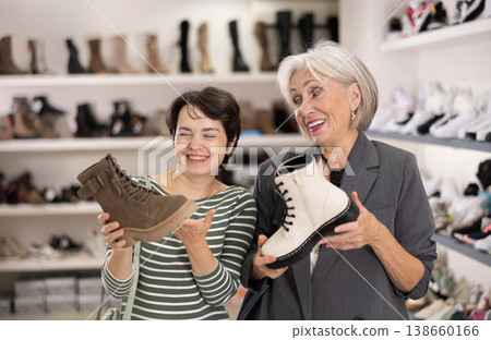 Two women are shopping in shoe store Two women are shopping in shoe store 138660166
