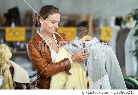Woman choosing a jacket for autumn Woman choosing a jacket for autumn 138660215