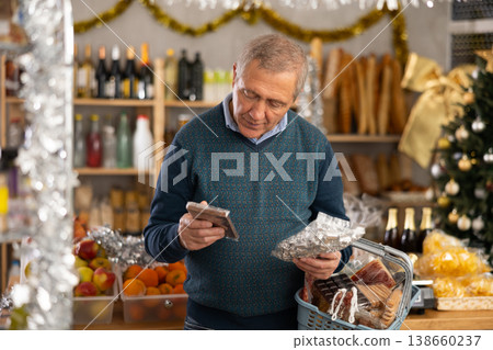 Portrait of mature man buying chocolate and chocolate candies for gift and celebrating Christmas Portrait of mature man buying chocolate and chocolate candies for gift and celebrating Christmas 138660237
