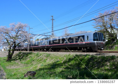 Odakyu 30000 series EXEα 4-car train and cherry blossoms in their final stages of blooming. Odakyu 30000 series EXEα 4-car train and cherry blossoms in their final stages of blooming. 138660287