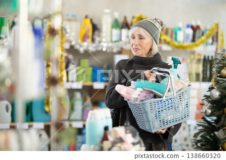 Portrait of happy woman with shopping basket in supermarket before Christmas 138660320