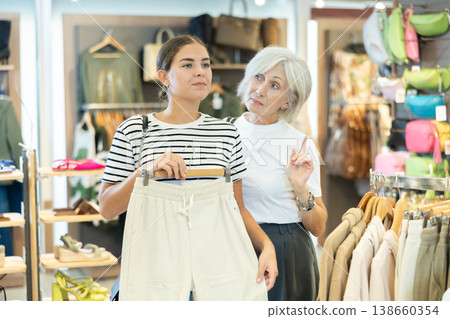 Shoppers inspect trousers 138660354