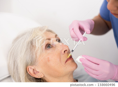 Old woman having mesotherapy procedure on her face 138660496