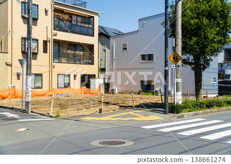 A vacant lot on a corner lot created by the demolition of a house A vacant lot on a corner lot created by the demolition of a house 138661274