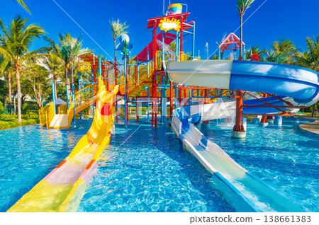 children's water park in the pool at resort on summer vacation. Colorful big aquapark with slides for kids 138661383