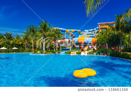 water park with slides and pipes for active extreme recreation at resort in summer. Big aquapark with a pool in tropics 138661388