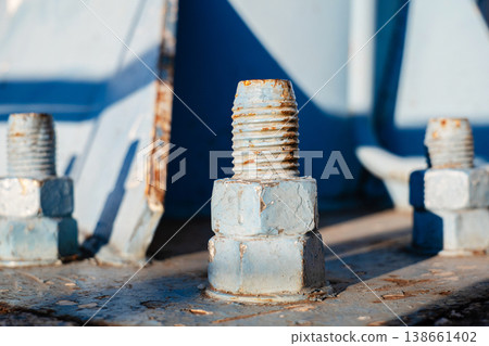 Macro shot of weathered blue painted steel bolts with visible rust and texture Macro shot of weathered blue painted steel bolts with visible rust and texture 138661402