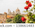 Florence cityscape with Duomo and Giottos Campanile framed by red flowers 138661483