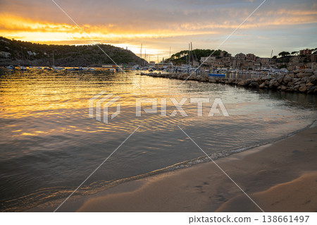 Golden sunset illuminates Port de Soller Majorca harbor, boats, and coastal town Golden sunset illuminates Port de Soller Majorca harbor, boats, and coastal town 138661497