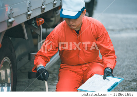 Truck inspection using a hammer Truck inspection using a hammer 138661692