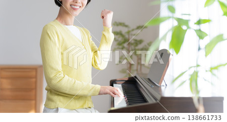 A woman playing an electronic piano at home A woman playing an electronic piano at home 138661733