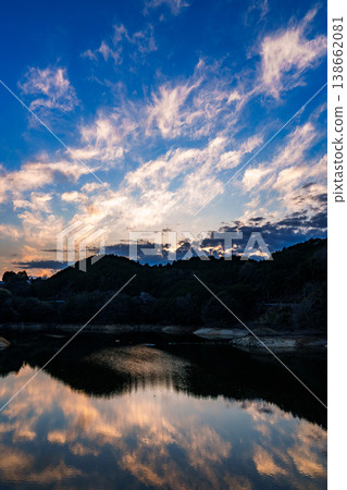 Spring 2026, after sunset: Beautiful sunset sky above Lake Nunome, golden scattered clouds and their reflection on the lake surface (Part 2) Spring 2026, after sunset: Beautiful sunset sky above Lake Nunome, golden scattered clouds and their reflection on the lake surface (Part 2) 138662081