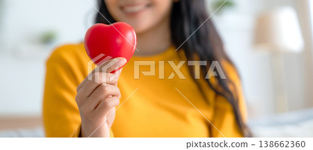 Close-up hand of asian woman holding red heart Close-up hand of asian woman holding red heart 138662360