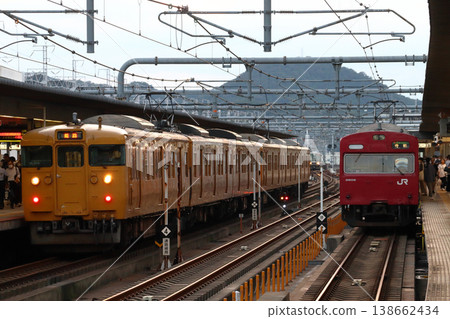 Sanyo Main Line 115 series train and Bantan Line 103 series train lined up at Himeji Station 138662434