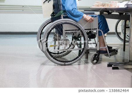 Senior men riding a wheelchair Senior men riding a wheelchair 138662464