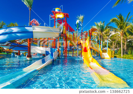 children's water park in the pool at resort on summer vacation. Colorful big aquapark with slides for kids 138662725